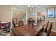 Inviting dining room featuring a wood table, staircase view, and access to the kitchen at 1154 Ridge Hollow Ln, Lawrenceville, GA 30043
