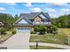 Charming two-story home boasts a brick facade, blue accents, and a well-manicured front yard at 1154 Ridge Hollow Ln, Lawrenceville, GA 30043