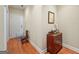 Hallway showcasing hardwood floors, white door, small dresser, and subtle decor at 1154 Ridge Hollow Ln, Lawrenceville, GA 30043