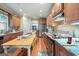 Bright eat-in kitchen features wooden cabinets, tile backsplash, and stainless steel appliances at 1154 Ridge Hollow Ln, Lawrenceville, GA 30043