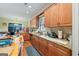 Bright eat-in kitchen features wooden cabinets, tile backsplash, and stainless steel appliances at 1154 Ridge Hollow Ln, Lawrenceville, GA 30043