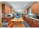 Bright eat-in kitchen features wooden cabinets, tile backsplash, and stainless steel appliances at 1154 Ridge Hollow Ln, Lawrenceville, GA 30043