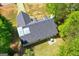 Aerial view of the roof, deck, and manicured lawn at 1012 Miss Amber Way, Locust Grove, GA 30248