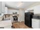 Kitchen with white cabinets, stone countertops, stainless steel appliances, and wood-look flooring at 1012 Miss Amber Way, Locust Grove, GA 30248