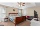 Spacious main bedroom features a tray ceiling, ceiling fan, and large windows for natural light at 1012 Miss Amber Way, Locust Grove, GA 30248