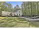 Backyard with in-ground pool and back exterior of the home with an adjacent deck at 160 Wills Way, Fayetteville, GA 30214