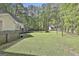 Lush backyard featuring a deck, shed, playground, fire pit, and perimeter privacy fencing at 160 Wills Way, Fayetteville, GA 30214