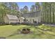 Expansive backyard with a large deck, fire pit, privacy fence and beautiful surrounding trees at 160 Wills Way, Fayetteville, GA 30214