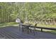 Large backyard with deck, fire pit, shed, swing set, and lush trees at 160 Wills Way, Fayetteville, GA 30214