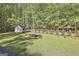 Spacious backyard featuring a shed, fire pit, swing set, and manicured lawn at 160 Wills Way, Fayetteville, GA 30214