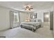 Bedroom with a queen bed, ceiling fan, and window with sheer curtains at 160 Wills Way, Fayetteville, GA 30214