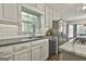 Bright kitchen with modern appliances, white cabinetry, and a view to the outdoors at 160 Wills Way, Fayetteville, GA 30214