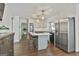 Spacious kitchen featuring a center island with seating and stainless steel refrigerator at 160 Wills Way, Fayetteville, GA 30214