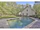 Back of house with large, in-ground swimming pool and wooden deck at 160 Wills Way, Fayetteville, GA 30214