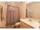 Well-lit bathroom featuring a shower-tub combination and a large vanity with sink at 44 Mediterranean Ave, Sharpsburg, GA 30277