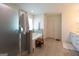 Modern bathroom with tiled floor, glass shower door, and soaking tub at 44 Mediterranean Ave, Sharpsburg, GA 30277
