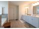 Bright bathroom with double vanity sinks, tile flooring, and a relaxing soaking tub at 44 Mediterranean Ave, Sharpsburg, GA 30277