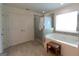 Spacious bathroom with tiled flooring, soaking tub, and glass door shower at 44 Mediterranean Ave, Sharpsburg, GA 30277