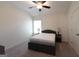 Carpeted bedroom with a ceiling fan, and bed with lamps on bedside tables at 44 Mediterranean Ave, Sharpsburg, GA 30277