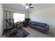 Bedroom featuring carpet flooring, ceiling fan, a gray couch, desk and workout equipment at 44 Mediterranean Ave, Sharpsburg, GA 30277