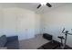 Bedroom with ceiling fan, carpet flooring, a gray couch, treadmill and 2 closets at 44 Mediterranean Ave, Sharpsburg, GA 30277