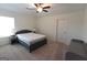 Bedroom with carpet flooring, ceiling fan, a bed with lamps on bedside tables at 44 Mediterranean Ave, Sharpsburg, GA 30277
