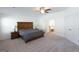 This spacious bedroom features carpet flooring, a ceiling fan, and ensuite bathroom access at 44 Mediterranean Ave, Sharpsburg, GA 30277
