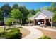 Community clubhouse with picnic tables and mature trees, providing residents a shaded space at 44 Mediterranean Ave, Sharpsburg, GA 30277