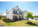 Exterior side view of a two-story white home with well-kept lawn and blue skies at 44 Mediterranean Ave, Sharpsburg, GA 30277