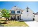 Beautiful two-story white farmhouse-style home with a well-manicured lawn and a two car garage at 44 Mediterranean Ave, Sharpsburg, GA 30277