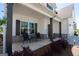 Covered front porch with stone accents and seating, perfect for relaxing outdoors at 44 Mediterranean Ave, Sharpsburg, GA 30277