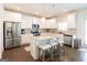 Modern kitchen featuring stainless steel appliances, a tile backsplash and an island with barstools at 44 Mediterranean Ave, Sharpsburg, GA 30277