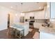 Stylish kitchen with stainless steel appliances, island with seating, and pendant lighting at 44 Mediterranean Ave, Sharpsburg, GA 30277