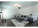 Comfortable living room with a ceiling fan, a cozy sofa, and a stylish coffee table at 44 Mediterranean Ave, Sharpsburg, GA 30277