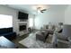 Comfortable living room with a fireplace and a ceiling fan, creating a cozy atmosphere at 44 Mediterranean Ave, Sharpsburg, GA 30277