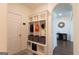 Hall tree in mudroom offers seating and storage with an entry door at 44 Mediterranean Ave, Sharpsburg, GA 30277