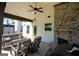 Stone patio area featuring a fireplace, ceiling fan and furniture at 44 Mediterranean Ave, Sharpsburg, GA 30277
