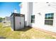 A gray storage shed is placed beside the white siding of the home, adding exterior storage at 44 Mediterranean Ave, Sharpsburg, GA 30277