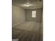 Neutral bedroom featuring gray carpet, a window, and a modern light fixture at 2039 Faith Cv, College Park, GA 30349