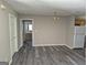 Open dining room with laminate floors and a view to the bathroom and kitchen at 2039 Faith Cv, College Park, GA 30349