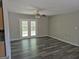 The living room features gray laminate flooring, neutral paint, a ceiling fan, and access to the rear exterior at 2039 Faith Cv, College Park, GA 30349