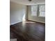 Bright bedroom featuring hardwood floors and natural light from the windows at 5949 Tyree Rd, Winston, GA 30187