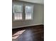 Bright bedroom featuring hardwood floors and natural light from the windows at 5949 Tyree Rd, Winston, GA 30187