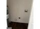 A utility room with a water heater and washing machine hookups over a dark wood floor at 5949 Tyree Rd, Winston, GA 30187
