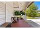 Back porch with outdoor table and chairs, grill, and wooded backyard view at 2354 Hamilton St, Hampton, GA 30228