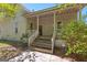 Inviting covered front porch with wooden steps and railing, perfect for relaxing outdoors at 2354 Hamilton St, Hampton, GA 30228
