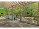 Spacious covered porch with white railings, offering serene outdoor views of the surrounding greenery at 2354 Hamilton St, Hampton, GA 30228