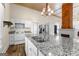 Bright kitchen features a large granite island, white cabinetry, and stainless steel appliances at 2354 Hamilton St, Hampton, GA 30228
