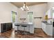 Bright kitchen with a granite island, stainless steel appliances, and modern stylish bar stool seating at 2354 Hamilton St, Hampton, GA 30228
