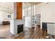 Open-concept living room with a striking brick pillar and modern finishes, creating a cozy ambiance at 2354 Hamilton St, Hampton, GA 30228